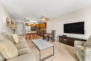 a living room with a couch and a flat screen tv at Kihei Akahi D-104 in Wailea