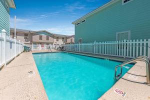 a swimming pool in front of a building at M & S Turtle Cove in Port Aransas