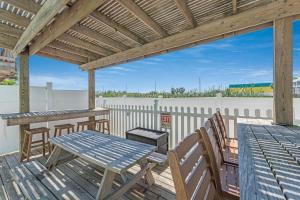 a patio with a table and chairs on a deck at M & S Turtle Cove in Port Aransas +2 photos