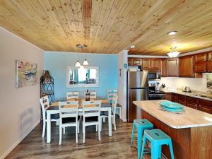 a kitchen with a table and chairs and a dining room at My Happy Place in Mustang Beach
