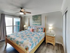 a bedroom with a bed and a ceiling fan at My Happy Place in Mustang Beach