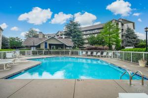 a swimming pool in front of a house at Rock-a-While Whispering Pines 214 in Pigeon Forge