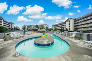 a large swimming pool with chairs in a building at Rock-a-While Whispering Pines 214 in Pigeon Forge