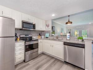a kitchen with white cabinets and stainless steel appliances at Lazy Bears Den 2103 in Pigeon Forge
