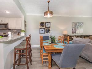 a dining room and living room with a table and chairs at Lazy Bears Den 2103 in Pigeon Forge