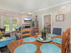 a dining room and living room with a table and chairs at Lazy Bears Den 2103 in Pigeon Forge +29 photos