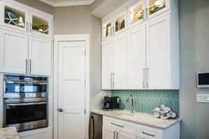 a kitchen with white cabinets and a sink at The Sanctuary in Padre Island
