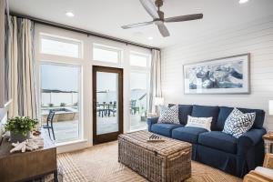 a living room with a blue couch and a window at The Sanctuary in Padre Island +33 photos