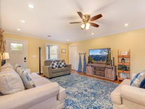 a living room with two couches and a flat screen tv at Sunrise Cove in Dandridge