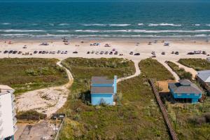 an aerial view of a beach with a blue building at Crandalls Cottage in Port Aransas