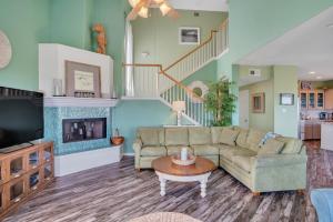 a living room with a couch and a fireplace at Crandalls Cottage in Port Aransas +21 photos