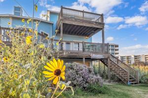 a house with a deck on the side of it at Crandalls Cottage in Port Aransas