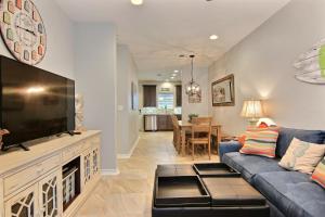 a living room with a large flat screen tv at Surfin Seahorse in Port Aransas