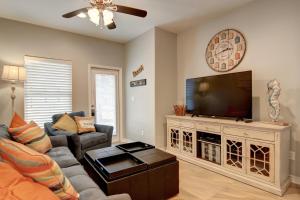 a living room with a couch and a television at Surfin Seahorse in Port Aransas