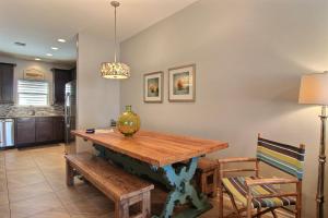 a dining room with a wooden table and chairs at Family Tides Beach House in Port Aransas