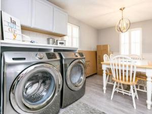 a kitchen with a washing machine in a kitchen at Cape Cod Cottage in Port Aransas +15 photos