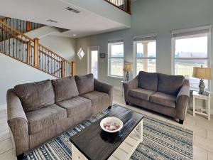 a living room with a couch and a table at Sandy Starfish in Port Aransas