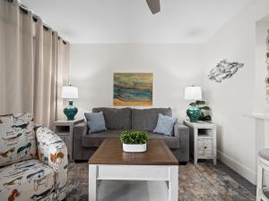 a living room with a couch and a table at Laguna Reef #311 - Heavenly Hill in Rockport