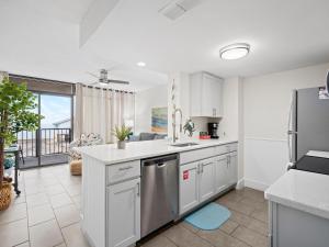 a kitchen with white cabinets and stainless steel appliances at Laguna Reef #311 - Heavenly Hill in Rockport +28 photos
