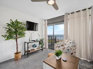 a living room with a couch and a table with a tree at Laguna Reef #311 - Heavenly Hill in Rockport