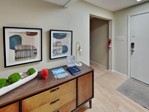 a living room with a wooden dresser and a room at The Crows Nest in Ruidoso