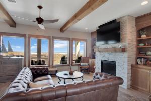a living room with a leather couch and a fireplace at Itll Do in Padre Island