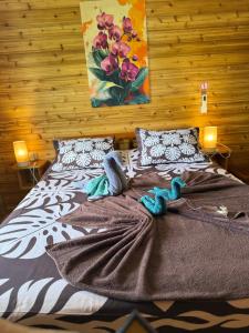 a bed with a blanket and two stuffed animals on it at Maroe Bay Lodge in HUH