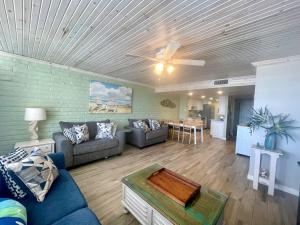 a living room with a couch and a table at Pearl Marlin in Port Aransas