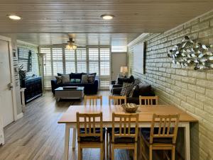 a dining room and living room with a table and chairs at Pearl Marlin in Port Aransas