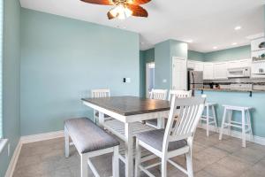 a kitchen and dining room with a table and chairs at Sandbar in Port Aransas