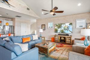 a living room with a blue couch and a tv at Beach-A-Holic in Padre Island