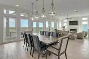 a dining room and living room with a table and chairs at BeachHouse Bliss in Padre Island