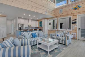 a living room with two couches and a table at Ocean Spirit in Port Aransas