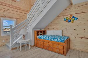 a bedroom with a bed in a wooden house at Ocean Spirit in Port Aransas