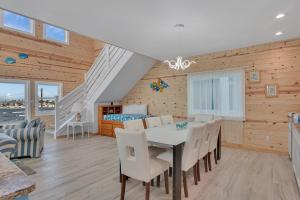 a dining room with a table and chairs and a bedroom at Ocean Spirit in Port Aransas +26 photos