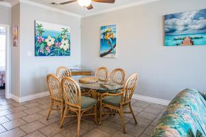 a dining room with a table and chairs at 3 Sheets To the Zin in Port Aransas