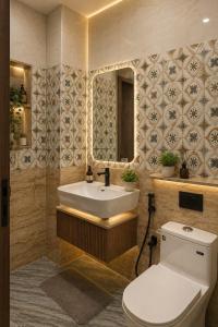 a bathroom with a toilet and a sink and a mirror at Hotel Prime Grand Residency by Rd Hotels #Most Premium Hotel in vrindavan #Lift #Parking #Fully Ac in Chhatikara