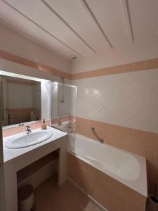 a bathroom with a sink and a bath tub at Auberge des Veillees in Blesle +12 photos
