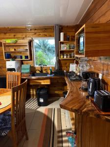 a kitchen with wooden walls and a sink and a counter at Maroe Bay Lodge in HUH +42 photos