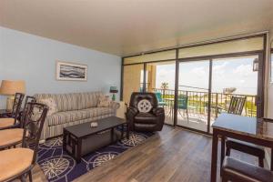 a living room with a couch and a balcony at Laguna Reef #208 - Sea Happiness in Rockport
