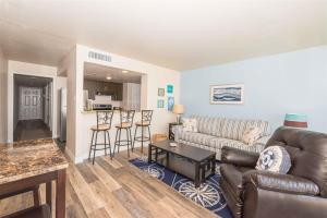 a living room with a couch and a table at Laguna Reef #208 - Sea Happiness in Rockport