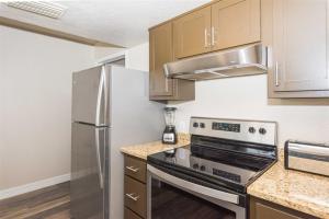 a kitchen with a stove and a refrigerator at Laguna Reef #208 - Sea Happiness in Rockport