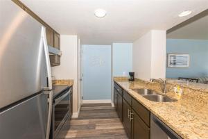 a kitchen with a stainless steel refrigerator and a sink at Laguna Reef #208 - Sea Happiness in Rockport +24 photos