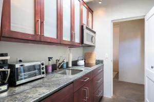 a kitchen with a sink and a microwave at Fiddlers Retreat in Santa Fe