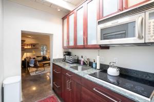 a kitchen with a sink and a microwave at Fiddlers Retreat in Santa Fe