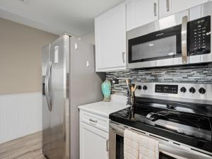 a kitchen with a stove and a refrigerator at Laguna Reef #205 - La Las in Rockport
