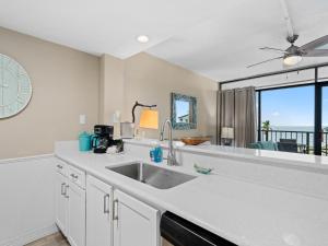 a kitchen with a sink and a large window at Laguna Reef #205 - La Las in Rockport
