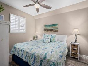 a bedroom with a bed and a ceiling fan at Laguna Reef #205 - La Las in Rockport +30 photos