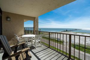 a balcony with a table and chairs and the ocean at Laguna Reef #315 - Bayview Retreat in Rockport