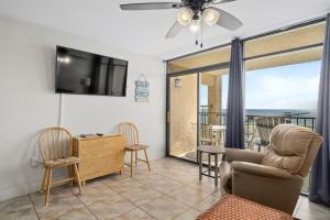 a living room with a flat screen tv and chairs at Laguna Reef #315 - Bayview Retreat in Rockport